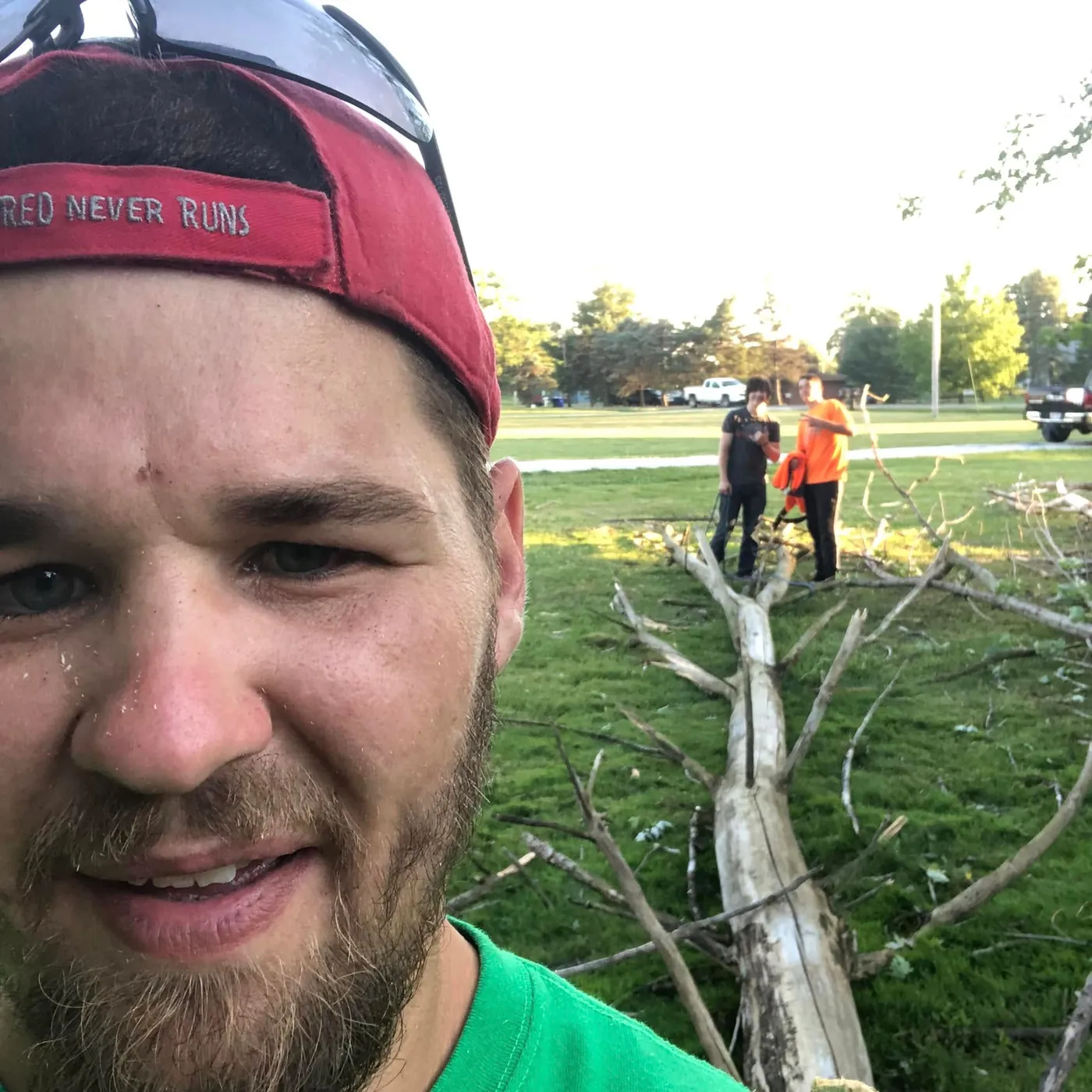 Portage County Tree Service on site, with the crew clearing a downed tree in the background